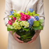 flowers in a clear vase against a neutral background
