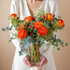 Bouquet of orange roses and greenery 