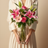 pink flowers in a clear vase against a beige background