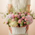 Elegant pastel blooming basket box with hydrangea, roses, orchids, Eustoma, and lilies beautifully arranged in a luxury floral design.