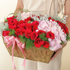 Elegant flower basket with red roses, pink Eustoma, pink hydrangeas, and seasonal foliage beautifully arranged in a luxury floral design.