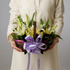 Elegant wooden flower basket with Casablanca white lilies, white roses, seasonal foliage, and delicate fillers beautifully arranged in a luxury floral design.