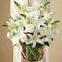 Bouquet of white flowers held by a person against a beige background