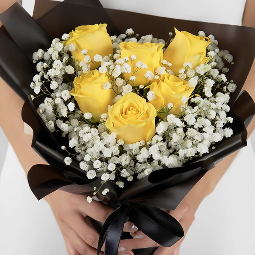 Bouquet of yellow roses with black wrap held by hands on a white background
