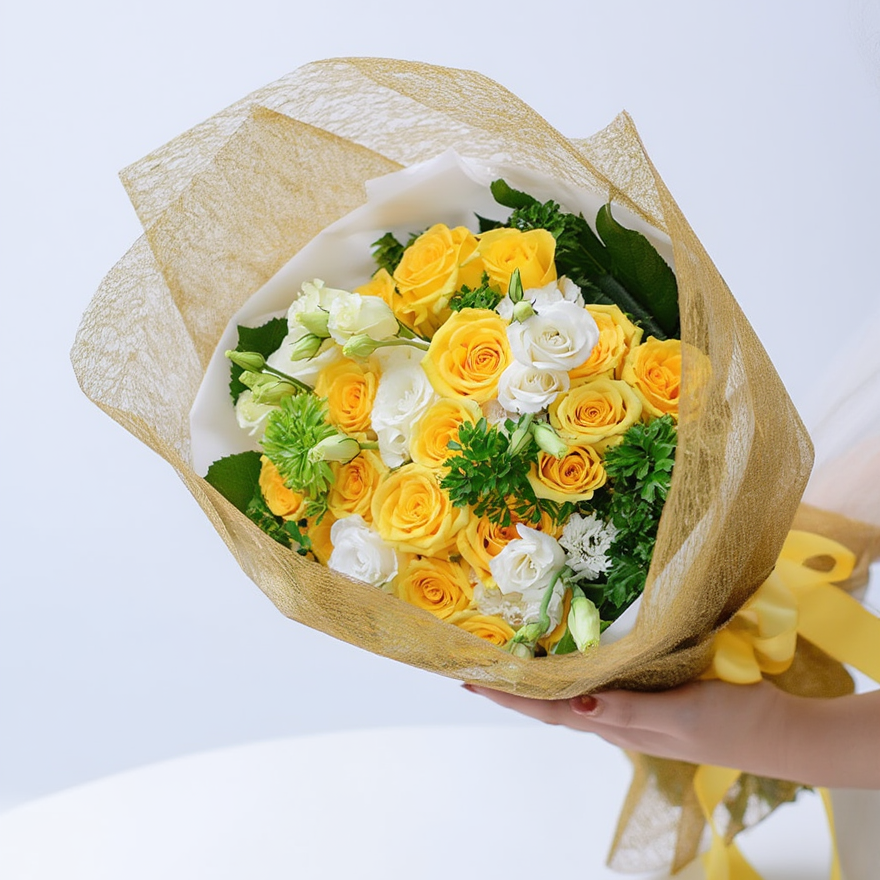 Bouquet of yellow and white flowers wrapped in brown paper held by a hand on a light gray background
